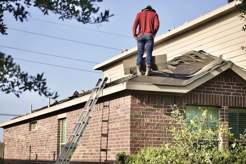 Professional roofer working on a residential roof in Lower Makefield